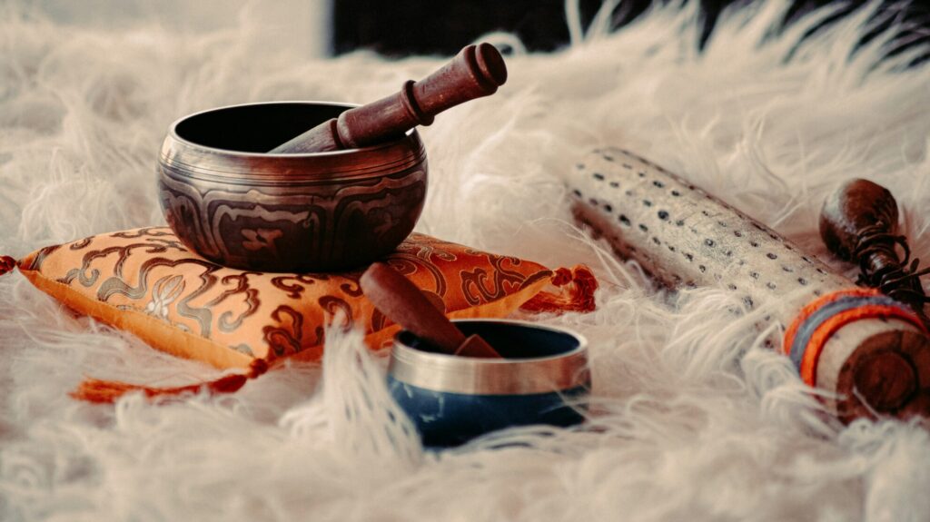 Crystal singing bowls arranged for a sound bath session, used to create gentle vibrational tones that promote relaxation, balance, and a calming sensory experience.