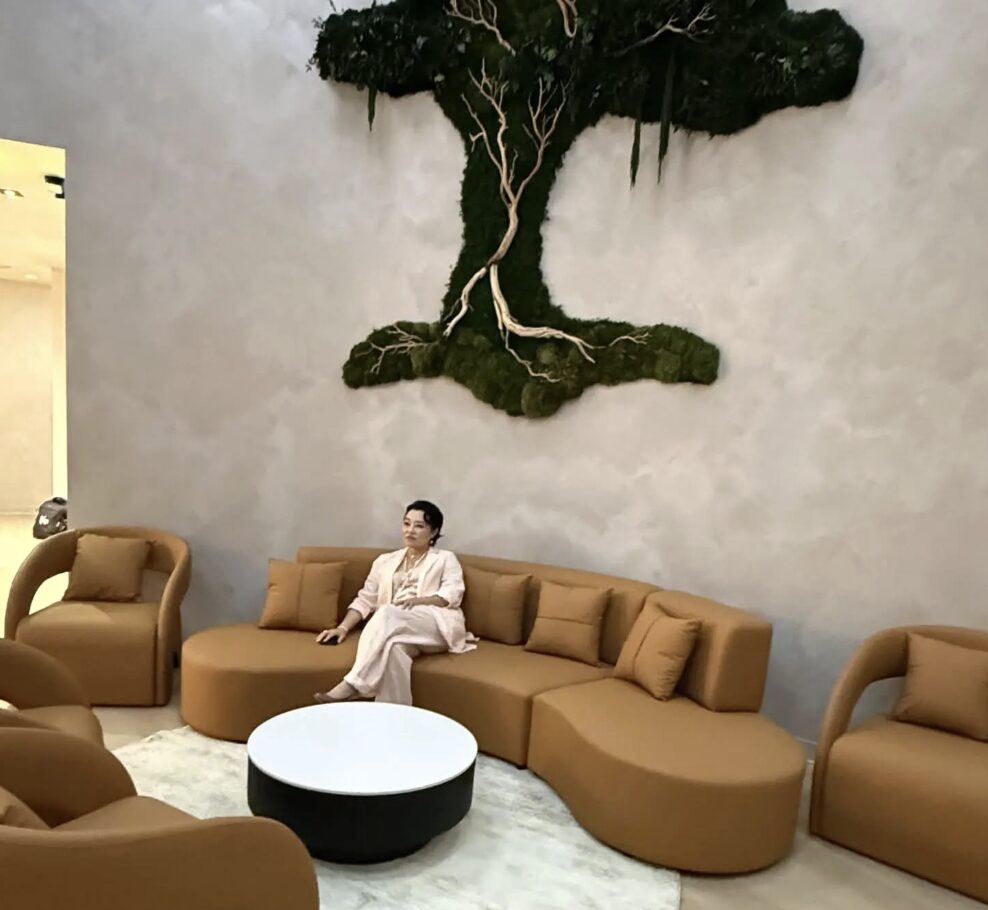 Inna Lee reflecting on a couch in waiting room